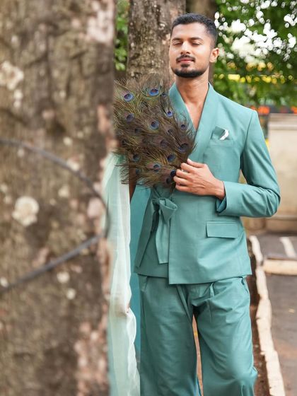 A serene moment in a unique, draped suit, connecting with nature while showcasing a designer piece.