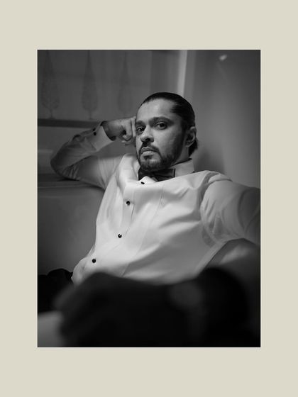 A handsome black and white portrait of the groom. His confident expression and classic tuxedo make for a timeless and striking image.