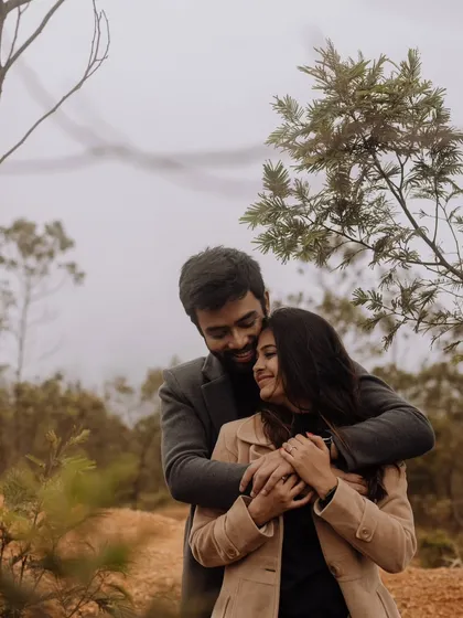 A cozy and loving hug amidst a misty, wooded landscape. This image evokes a sense of warmth, protection, and quiet intimacy.