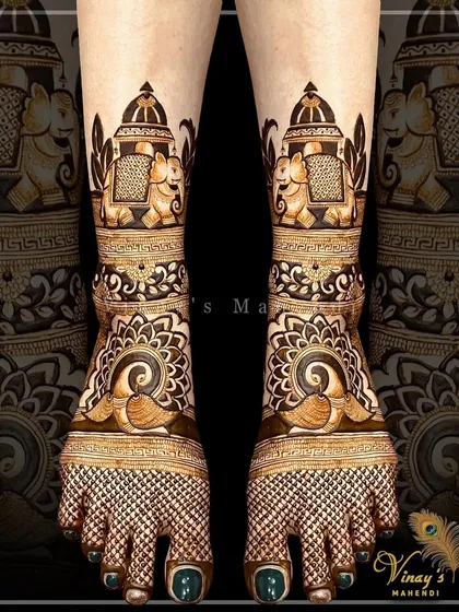 This bridal feet design features elephants inside domed structures on the ankles, with peacocks and intricate jaal work covering the rest of the feet.