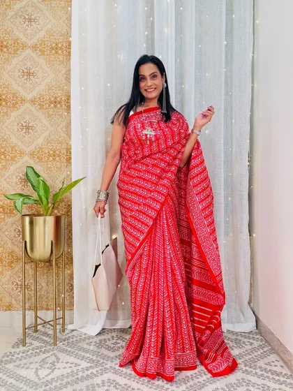 A bright red printed saree that is perfect for adding a splash of color to your work wardrobe. The lightweight fabric makes it comfortable for all-day wear.