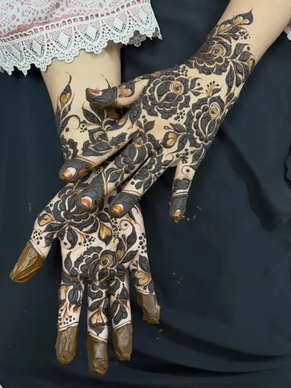A posed shot of the bold flower design, showing how it beautifully adorns the hands.