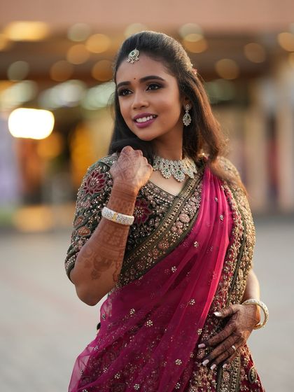 My beautiful bride Dr. Saruna looking radiant during her reception photoshoot in Erode. Her glam makeup and soft, wavy hair perfectly complement her intricately embroidered lehenga.