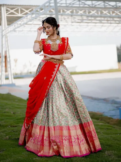 A classic pose showing the full silhouette of a traditional half saree. The outdoor setting at Ditya Venue provides a clean and elegant backdrop for this celebrity shoot.