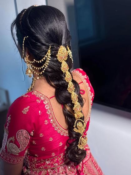 A detailed look at the stunning traditional South Indian bridal braid, adorned with intricate gold hair accessories. This is part of the complete bridal styling I offer.