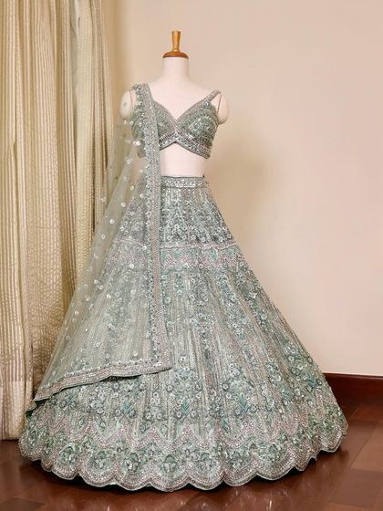 A full view of the teal green lehenga on a mannequin. This is a stunning choice for an engagement, sangeet, or reception.