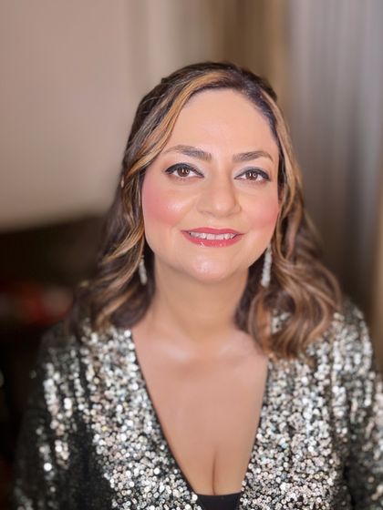 A close-up portrait of this mature client, showcasing a glowing and youthful makeup look.