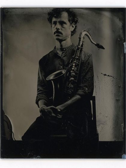 The timeless appeal of a musician and his instrument, captured with a 19th-century process. This is the kind of portrait that becomes a family heirloom.