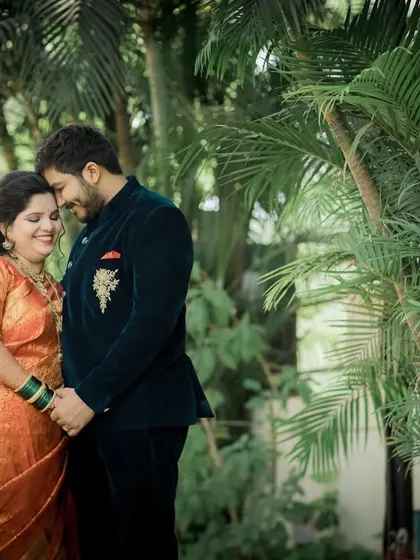 A sweet portrait of the newly married couple holding hands in a quiet garden, enjoying their first moments as husband and wife.