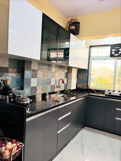 Another angle of the grey and white kitchen, showing the practical placement of the sink and cooking area for an efficient workflow.