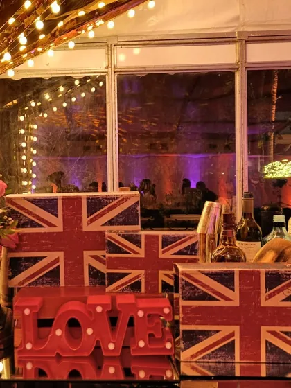 Union Jack-themed boxes and a red 'LOVE' sign create a bold, graphic statement. This decor perfectly captures the cool, modern British vibe of the 'London Calling' theme.