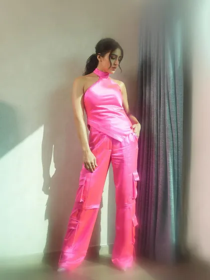 A full-length view of the vibrant pink outfit, maintaining the soft and dreamy lighting effect throughout the frame.