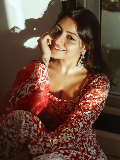 A warm, sun-kissed portrait of actress Symrann K in a beautiful red ethnic outfit. This photo highlights my skill in ethnic glamour photography, using natural light to create a soft and inviting mood.