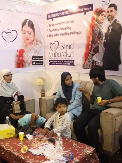 Here I am at a business expo, personally consulting with a family. The banner behind us highlights my core services, including Background Verification and Premarital Screening, which are central to ensuring a secure and transparent match for you.