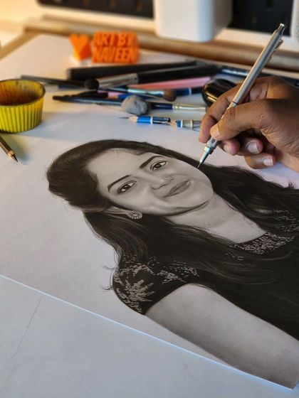 A shot of my hand adding the final details to the portrait, showcasing the careful work that goes into every piece.