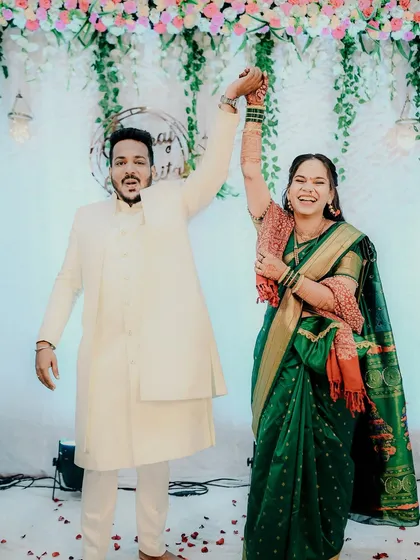 Pure celebration! The couple raises their hands in joy after their ring ceremony. Capturing this peak moment of happiness is essential for telling the story of their engagement day.