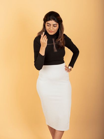 A classic and elegant studio portrait. The professional attire and simple background make this an ideal corporate headshot or branding photo.