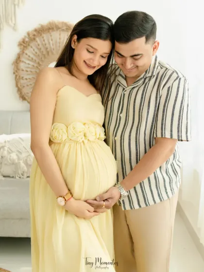 In the soft light of my boho-themed studio, this portrait captures the gentle and loving anticipation of a couple waiting to meet their baby.