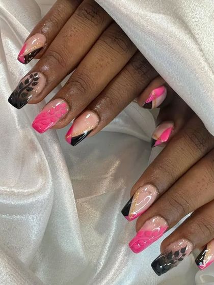 A bold and artistic nail set combining pink marble, black tips, and delicate leaf brush art.