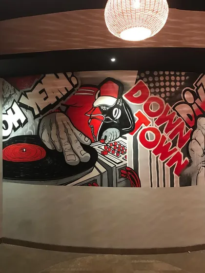 We brought the beats to the wall with this DJ-themed section of the mural. The artwork reflects the "Eat. Drink. Party." motto of the establishment.