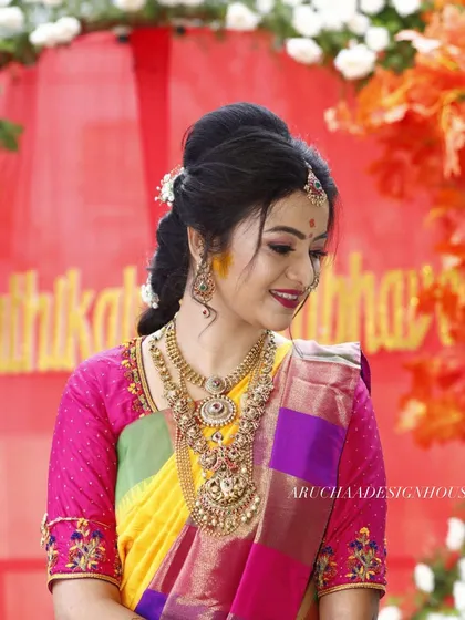 A happy bride is the best review. I loved creating this vibrant pink blouse with detailed embroidery on the sleeves to perfectly complement her multi-colored wedding saree.