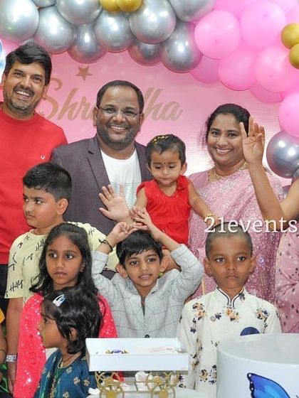 A big group photo showing all the kids and family enjoying the butterfly-themed party.