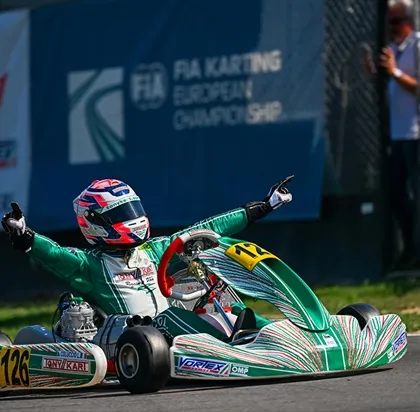 A moment of pure triumph. One of our drivers celebrates a victory at the FIA Karting European Championship, demonstrating our capability to compete and win on the global stage.