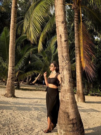 Finding shade under the palm trees in the Andamans. A black co-ord set with a crop top and skirt is a stylish and cool choice for a tropical getaway.