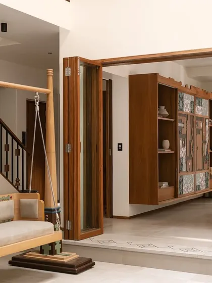 A closer look at the Kolam Pop oonjal, showing how it anchors the central courtyard. The design speaks to the adjacent sitting room and the sculptural staircase, creating a harmonious dialogue between traditional motifs and contemporary forms.