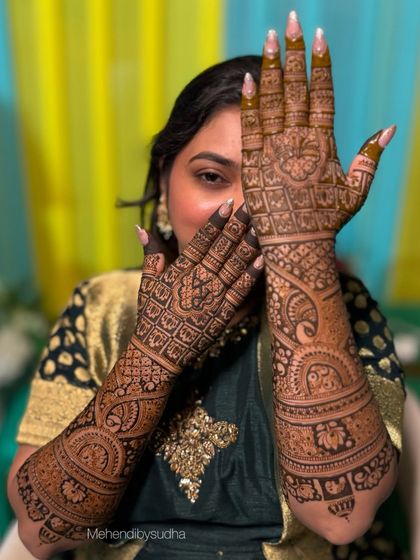 The beautiful bride Rutuja, giving a peek from behind her fully adorned hands. Her joy is palpable.