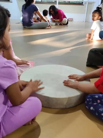 Two friends sharing a moment at the gathering drum. This is a beautiful example of how music helps children connect, cooperate, and learn to play together.
