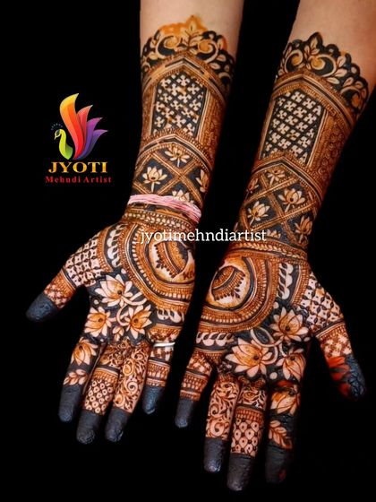 This design shows how different elements can come together in a full bridal set. Notice the detailed architectural jaali work on the forearm and the delicate lotus patterns on the palm and fingers.