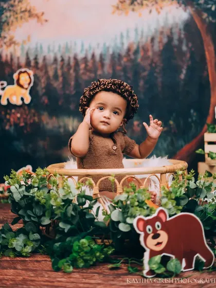 This little one is waving hello from the heart of the jungle. I use creative costumes and props to fully immerse your child in the theme.
