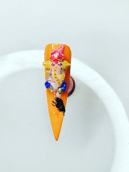 This is a 3D Ganesha that I sculpted using acrylic. This technique adds dimension and makes the nail art truly pop. I can customize the colors and details to your liking.