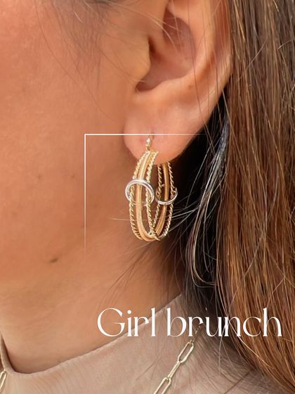 Perfect for a girl's brunch, these mixed-metal gold hoops are playful and stylish. The interlocking design adds a unique touch to a classic hoop earring.