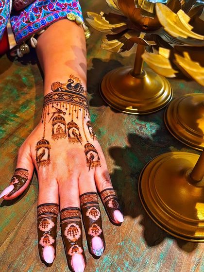 A single-hand view of the bird cage design, showing its delicate and artistic quality.