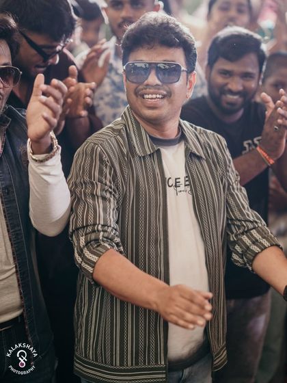 A guest enjoying the music and dancing at a carnival-themed wedding party.
