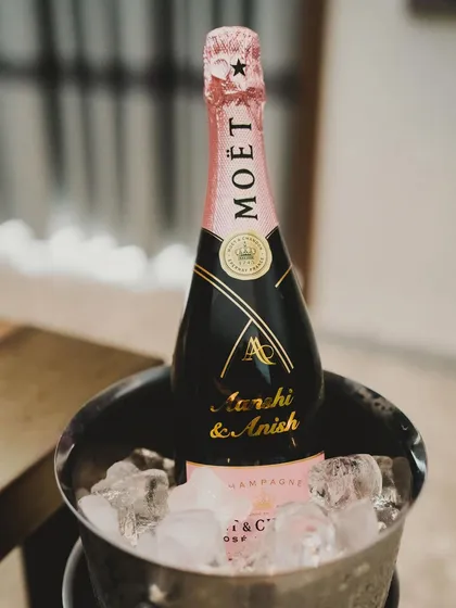 A personalized bottle of Moët champagne, featuring the couple's names and wedding monogram. This is the epitome of a luxurious and celebratory detail.