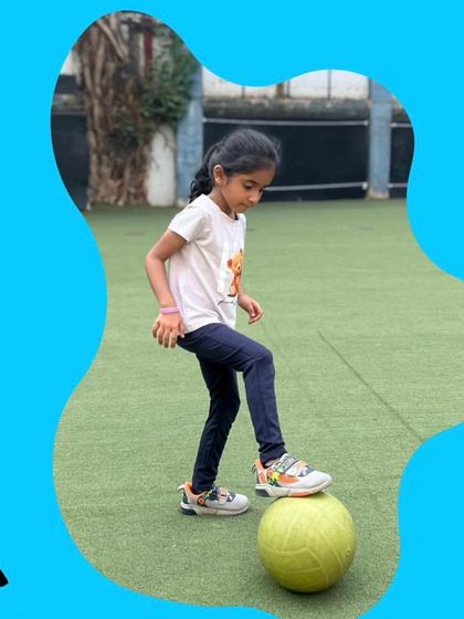 A simple moment of control and focus. This young player is practicing her footwork with a soccer ball, a key skill for building confidence in the game. Every small step of progress is a huge victory.
