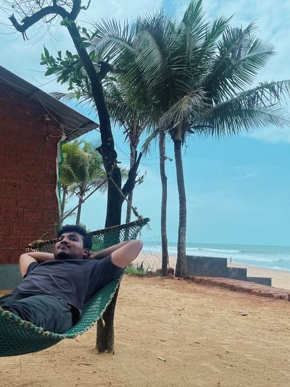 A traveler relaxing in a hammock at a beachside stay in Gokarna. This is the ultimate way to unwind.