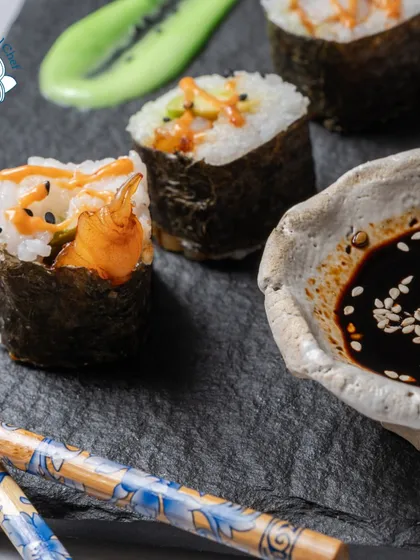 A close-up of my handcrafted sushi, showing the delicate details of the spicy mayo drizzle and toasted sesame seeds. I believe presentation is just as important as taste.