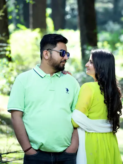 A sweet, candid moment where the couple shares a look in the middle of a sun-dappled forest. Capturing these in-between moments is key to my photography style.