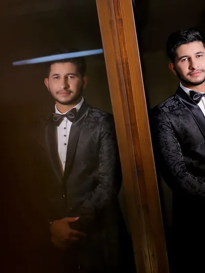 An artistic portrait of the groom using a mirror. This creative technique adds depth and a unique perspective to the photo.