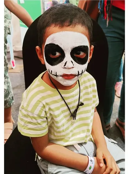 A spooky and fun full-face skeleton, perfect for Halloween parties or themed events. This look is created with high-contrast, non-toxic black and white paint for a dramatic effect.