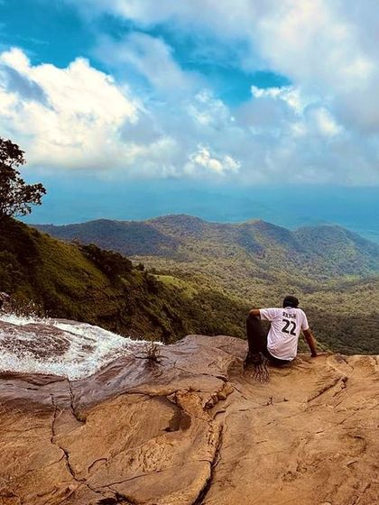 Taking a moment to soak in the vastness from the top of Bandaje Falls. The view of the valley below is just as impressive as the waterfall itself.