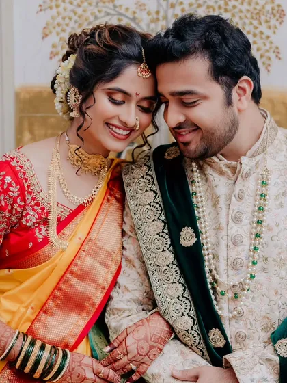 Such prettiness in one frame. A candid moment between the bride and groom, showcasing her soft, glowing makeup and traditional wedding attire.