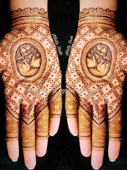 A custom designer mehendi with swan motifs in the center. This is a great example of a modern design that is still rooted in traditional imagery.
