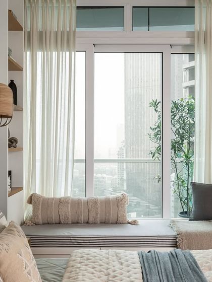 This master bedroom features two large windows offering stunning views. To maximize the space, I crafted a cozy window seat, an inviting spot for moments of relaxation, reading, and scenic contemplation.