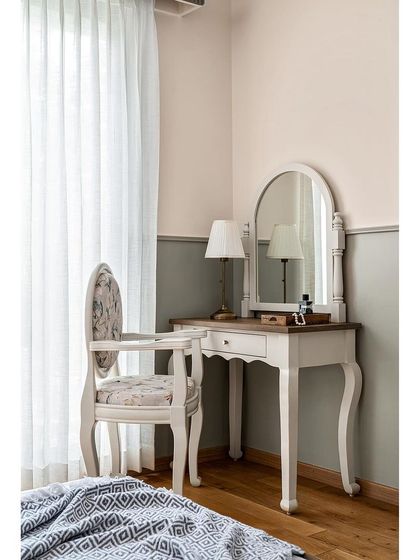 A detail shot of the vintage-style parents' bedroom. The classic lines of the vanity table and chair create a timeless and elegant corner for getting ready.