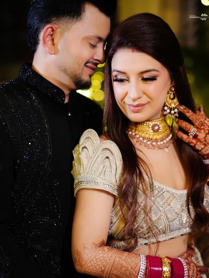 An intimate close-up of the couple. The bride's hand on the groom's face and their gentle smiles convey a deep sense of love and affection.
